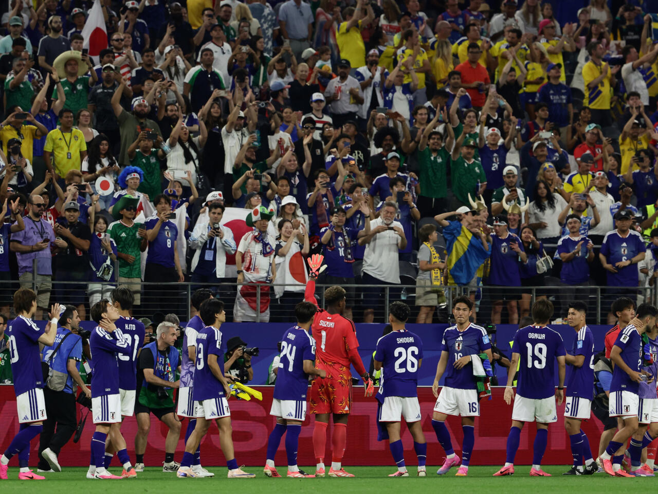 Brazil forward surrounded by Japan defenders during a tense World Cup match moment