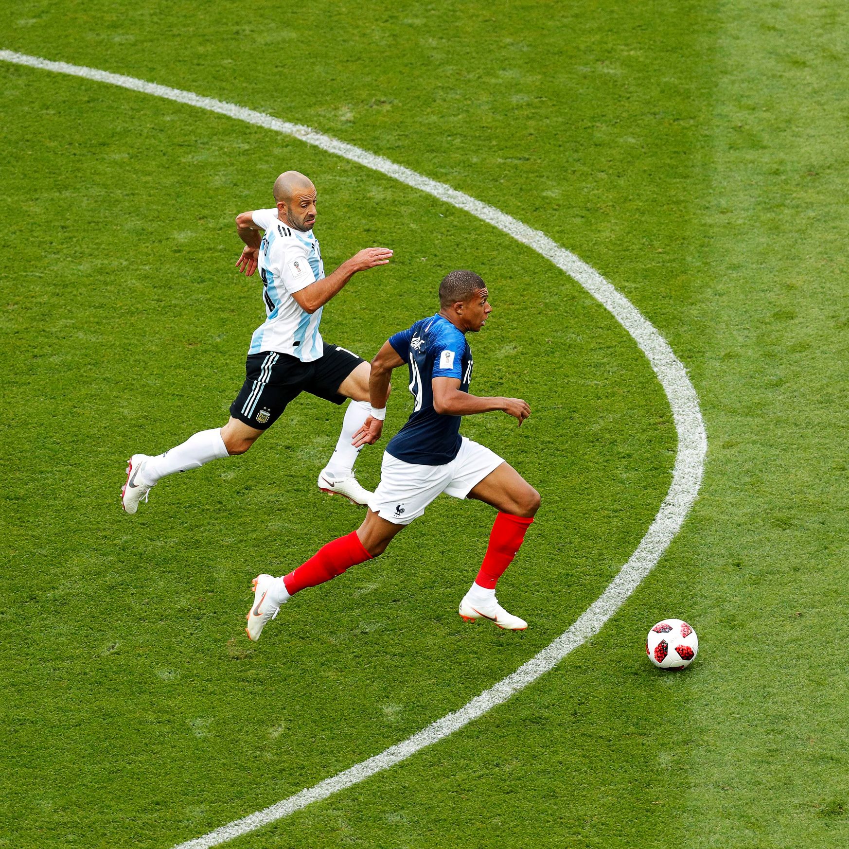 Kylian Mbappe sprinting past defenders during a decisive World Cup match for France