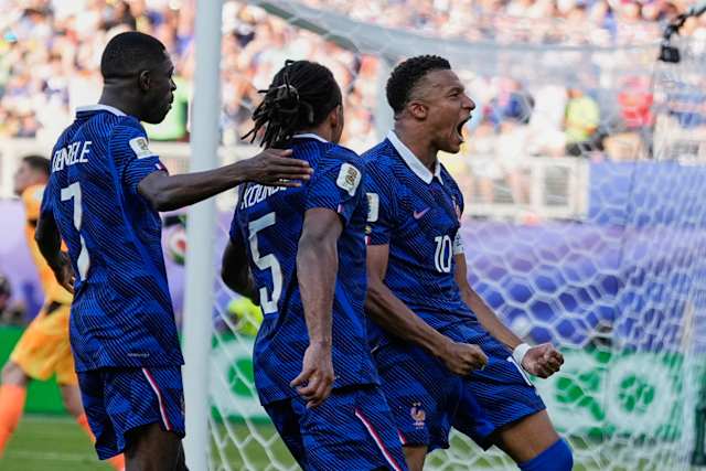 france players celebrating a knockout win as fans wave flags in a packed world cup stadium