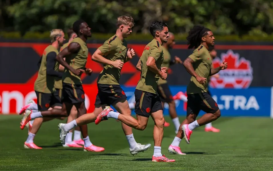 Canada and Morocco players preparing for a high-pressure World Cup match under bright stadium lights